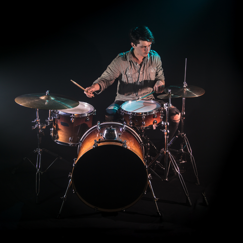 musician-playing-drums-black-background-beautiful-soft-light-emotional-play-music-concept (1)